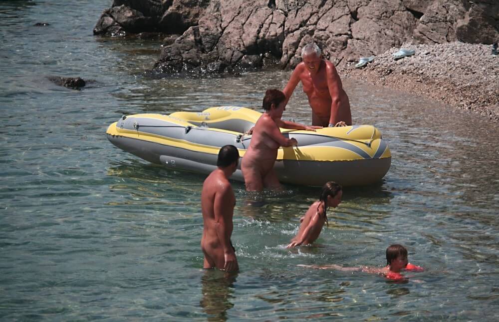 Lone Nudist in Yellow Boat photos - Nudism as a way to overcome body image issues and stereotypes