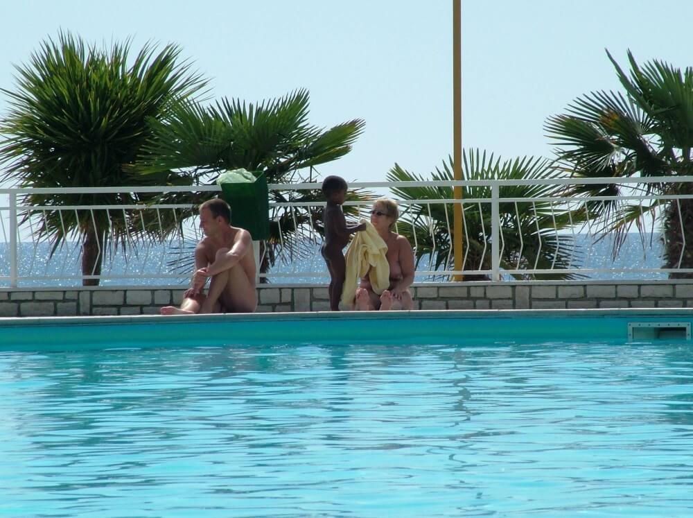 Photo of naturists in an outdoor pool - Core values and goals of nudist clubs and organizations